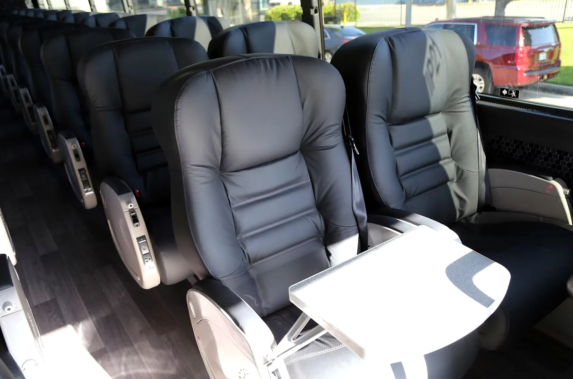 Four Season Travel VIP coach seating with a fold-out work table deployed between seats